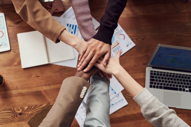 A small group working together around a table